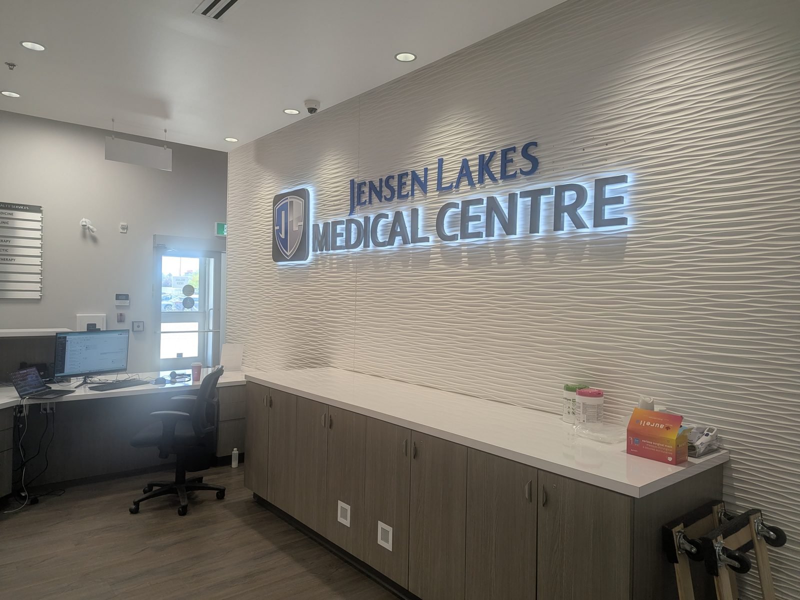 The illuminated Jensen Lakes Medical Centre sign above the reception desk