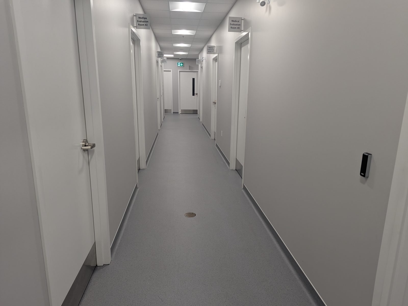 A level corridor leading to the treatment rooms, with no steps