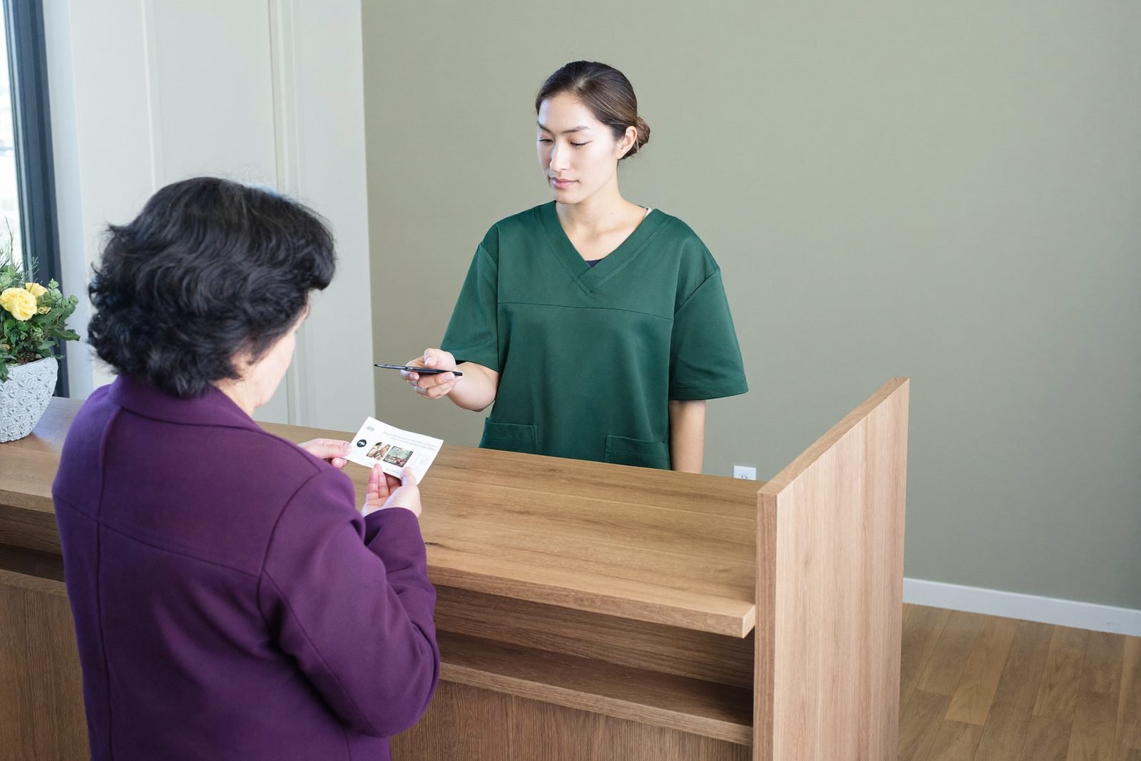 Direct billing being handled at the clinic reception desk at the end of a visit
