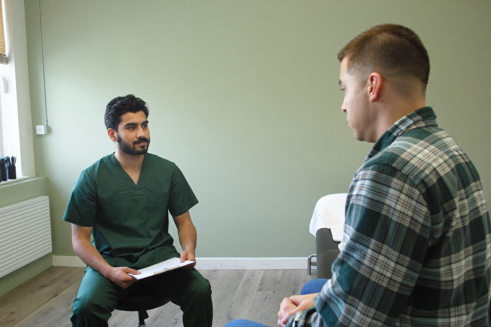 A clinician taking a patient history at the start of a first appointment