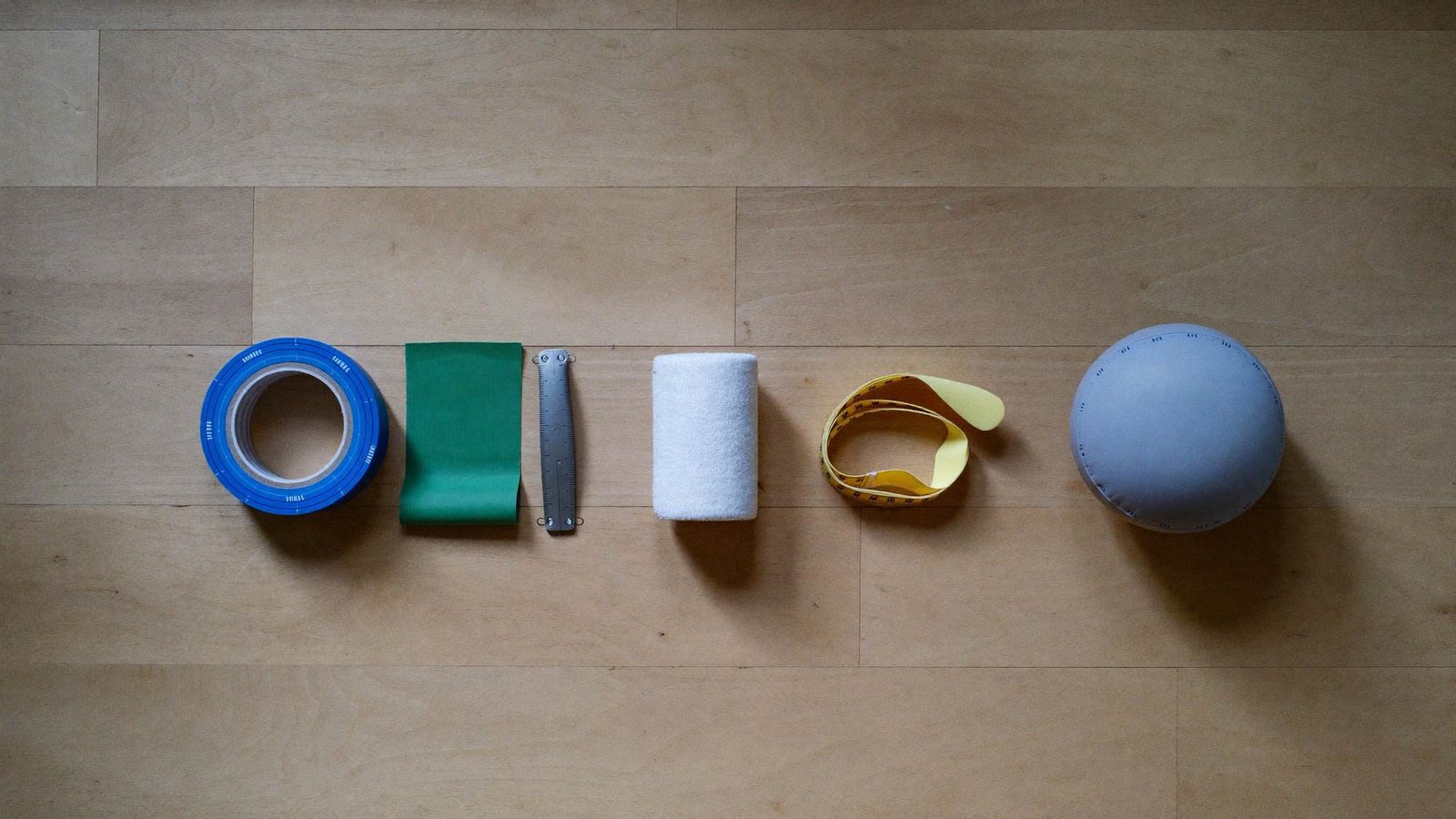 Short-stretch bandages, foam and a soft ball laid out for a compression appointment