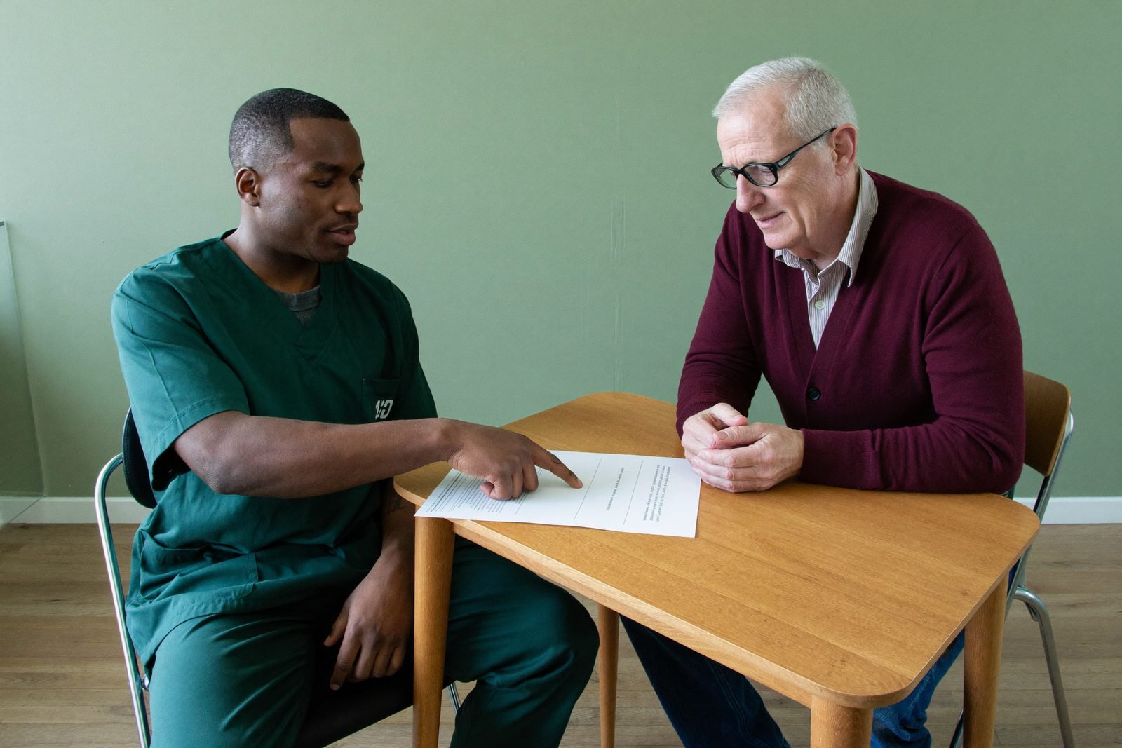 A clinician and patient going through a written plan together at the desk