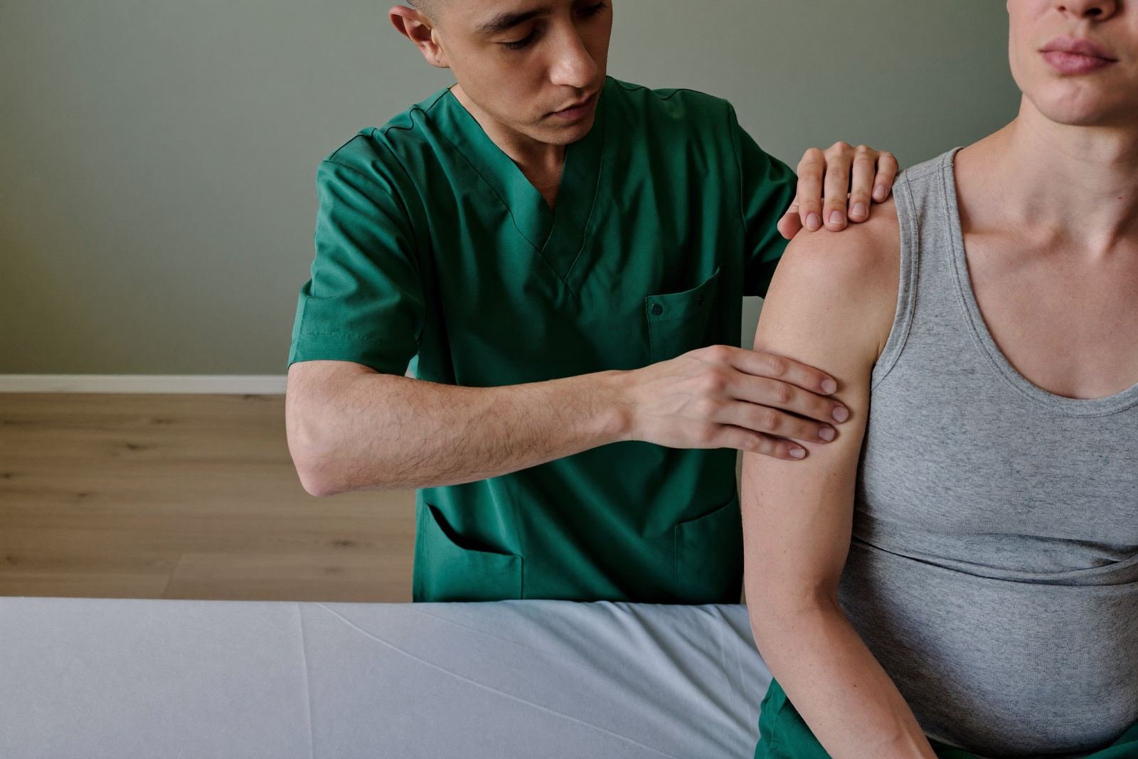 A clinician assessing the range of movement in a patient's shoulder